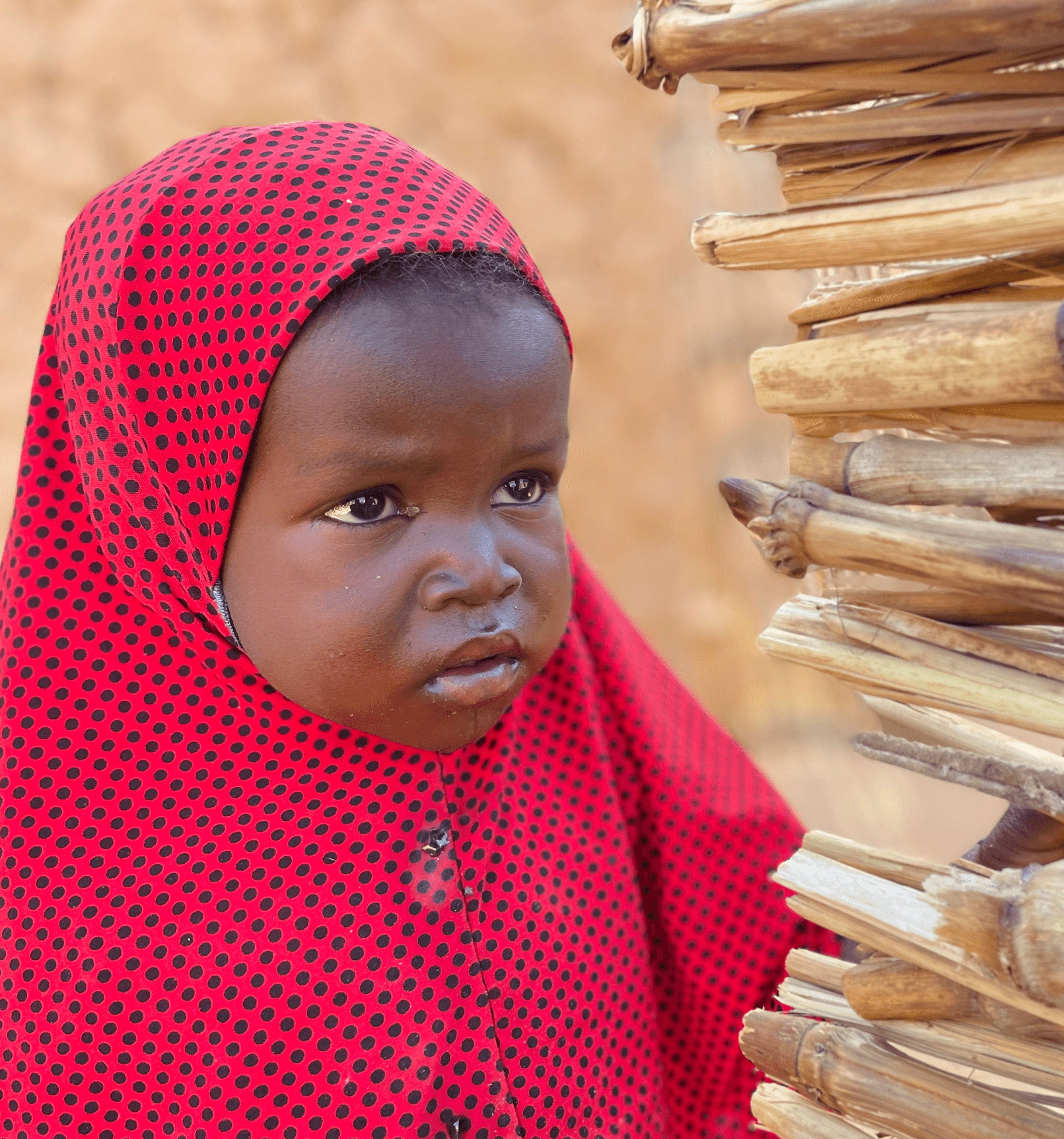 A child receiving a nutritious meal supported by Muntada Aid in Niger